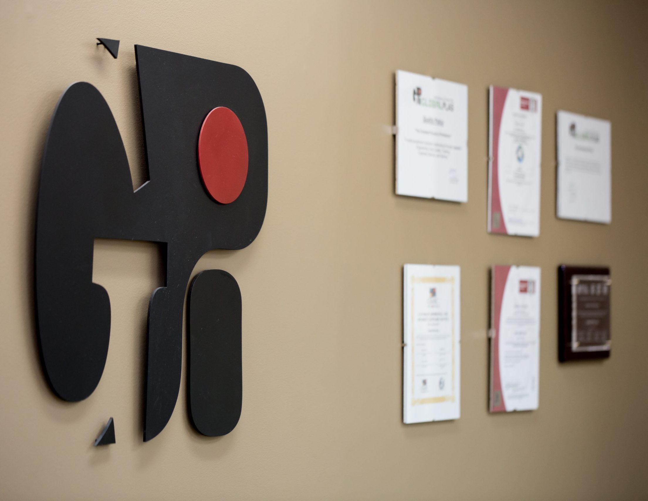 Picture of Global Plas Logo and Certifications on Wall